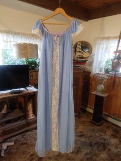 Made by Erica Loren,  tag says medium but it measures to be a size Large  to XL, 48 inches long, 42 inch bust and 22 inch diameter armholes,  blue color, has satin trim and lace accent on the front,  in good condition for her age,  I didn't see any issues. Light Blue Lace Trim Sleep Dress, Blue Lace Nightgown With Lace Trim, Light Blue Lace Trim Dress For Loungewear, Blue Lace Nightgown For Loungewear, Fitted Blue Sleepwear For Home, Blue Lace Nightgown For Sleep, Blue Lace Trim Dress For Loungewear, Fitted Light Blue Sleepwear With Lace Trim, Light Blue Fitted Sleepwear With Lace Trim