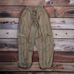 ** THIS LISTING IS FOR THE SIZE SMALL Harem Boho Comfy Pants. IF YOU NEED MEDIUM, LARGE OR XL, THAT IS A DIFFERENT LISTING ** Welcome to our vibrant world of Peruvian Yoga Harem Boho Comfy Pants! Handcrafted with care on the sun-drenched shores of Northern Peru, these pants are more than just clothing; they are a statement of freedom, comfort, and style. Indulge in the luxurious embrace of pure Peruvian cotton, renowned for its softness and breathability. Each pair of pants is meticulously craft Casual Brown Bottoms For Festival, Brown Casual Pants For Festivals, Casual Brown Pants For Festival, Brown Hippie Pants With Pockets, Hippie Brown Pants With Pockets, Baggy Casual Cargo Pants For Festivals, Casual Full Length Bottoms For Festival, Casual Bottoms With Side Pockets For Festivals, Boho Yoga Pants