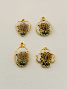 "Beautiful enameled yellow rose flowered pendant that is available in four shapes that we have combined with a new 14k gold plated snake chain. This is an ideal layering necklace to pair with larger pendants. The small dainty pendant measures 3/8\" x 3/8\" x 1mm thick and comes with a 14k gold plated snake chain" Gold Charm Necklace With Rose Flower Pendant, Gold Charm Necklace With Flower Pendant And Rose Design, Gold Charm Necklace With Flower Pendant, Gold Flower Pendant Charm Necklace, Nickel Free, Yellow Rose Flower, Dainty Pendant, Rose Necklace, Enamel Flower, Flower Pendant