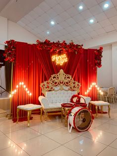 a red and gold stage set up for a birthday party