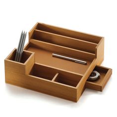 a wooden desk organizer with pen and pencils in the drawer, on a white background