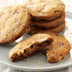 several cookies on a plate with one broken in half