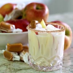 an apple cider is garnished with marshmallows and cinnamon