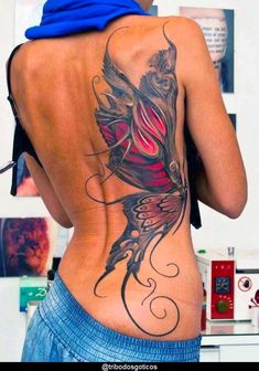 the back of a woman's body with tattoos on her lower and upper back