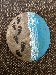 a painted rock sitting on top of a carpet