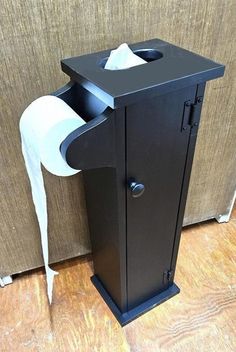 a toilet paper dispenser is on the floor next to a brown wall