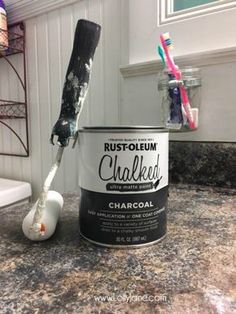 a paint can and brush sitting on top of a counter