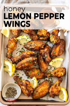 honey lemon pepper wings on a tray with lemons