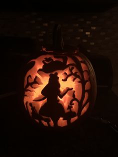 a carved pumpkin with an image of the wizard on it's face in the dark