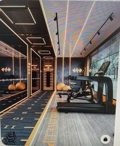 a gym with treadmills and exercise equipment in the center, along with large windows