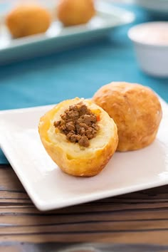 two small pastries on a white plate