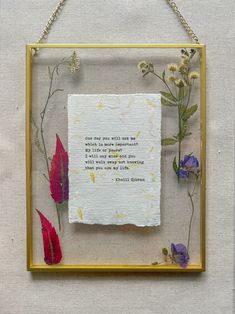 a piece of paper with some flowers on it and a quote written in the middle