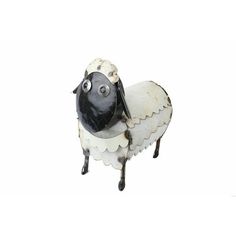 a black and white sheep figurine on a white background