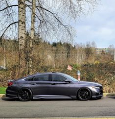 a grey car parked on the side of a road