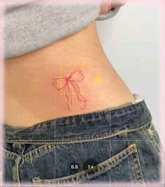 a woman's stomach with a small bow tattoo on the back of her belly