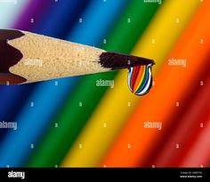 a pencil with a rainbow background - stock image