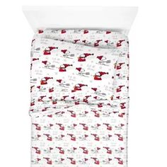 a bed with red and white sheets on top of it's head, in front of a white background