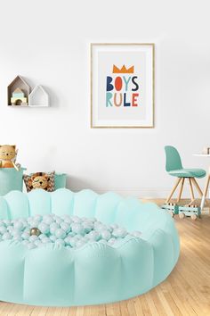 an inflatable bubble bed sits on the floor next to a teddy bear and other toys