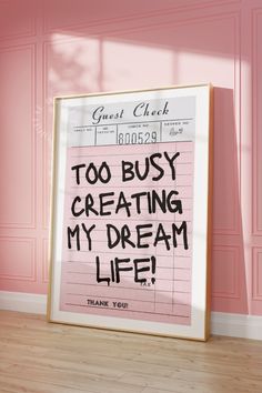 a pink poster with the words too busy creating my dream life written in black ink