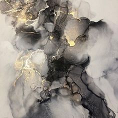 an abstract painting with black and gold paint on it's surface is shown in this image