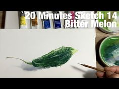 someone is painting a green leaf with watercolors