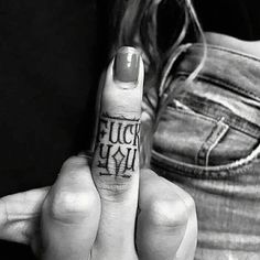 a woman holding up her finger with the word rock n roll written on it in black and white