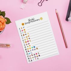 a notepad with emojtchery written on it next to a cup of flowers