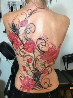 a woman's back with flowers and swirls on it