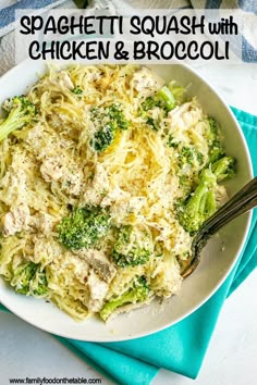 a white bowl filled with pasta and broccoli on top of a blue towel