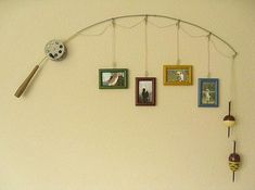 a wall with pictures hanging on it and a clock