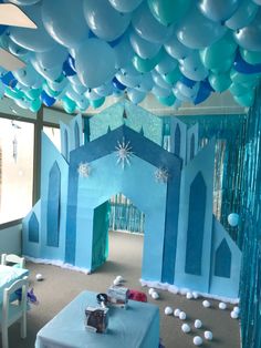 a room decorated with blue and white balloons