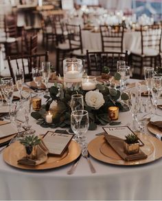 the table is set with place settings, candles and menus for guests to enjoy