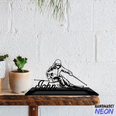 a wooden table topped with a cutting board and potted plant