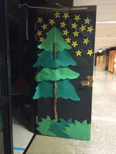 a door decorated to look like a christmas tree with stars on the top and bottom