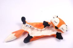 an orange and white stuffed animal laying on its side