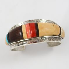 Tufa Cast Sterling Silver Cuff Bracelet featuring a Cobbled Inlay Design using Natural Kingman Turquoise, Fossilized Ivory, Mediterranean Coral, Pink Angel Coral, Ebony, and Ironwood. 1.125” Cuff Width5.5” Inside Measurement, plus 1” opening(6.5" Total Circumference - Medium) Luxury Traditional Cuff Bracelet With Inlay, Traditional Luxury Inlay Cuff Bracelet, Unique Luxury Bracelets With Inlay, Inlay Design, Pink Angel, Zuni Jewelry, Concho Belt, Navajo Jewelry, Stone Inlay