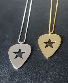 Brand New unique pendant design! Incorporating a Star within the Guitar Pick. - 925 Sterling Silver (Gold Plated) - Box Chain - 45.7 cm (18 inch) Chain - Pendant Measures 25mm x 21mm (1.2mm depth) - Weight 5.7 grams inc chain - Premium Leatherette Display Box - Available in Gold or Silver Star Guitar Pick, Star Things, Pick Guitar, Star Guitar, Guitar Pick Necklace, Funky Jewelry, Guitar Picks, Star Jewelry, Unique Pendant