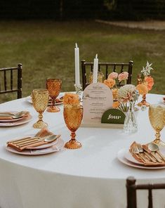 the table is set with gold and white dishes