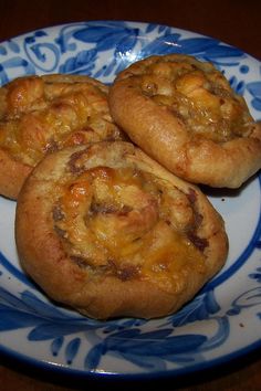 three small pastries on a blue and white plate