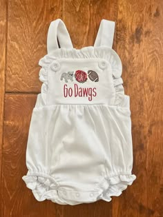 So cute for your little one to wear who loves UGA. This sunsuit is white  cotton LTC brand embroidered with UGA football. I can do this for boy or girl. I can also do a dress or shirt. just message me. White Cotton Bubble Romper, White Short Sleeve Cotton Bubble Romper, White Cotton Short Sleeve Bubble Romper, White Fitted Bubble Romper For Playwear, Fitted White Bubble Romper For Play, Cute Embroidered Cotton Bubble Romper, Casual White Bubble Romper For Playwear, White Short Sleeve Bubble Romper For Playwear, White Fitted Casual Bubble Romper