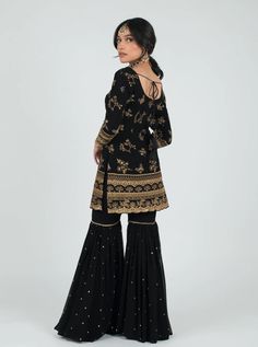 Sandook Essentials. Gharara. Georgette Composition. Thread & Faux Mirror Work.Be alluring in our Black Saiya Suit. The full sleeve blouse has gold thread work bordering the arms from wrist to elbow, transitioning into scattered floral patter... Black Gharara, Garara Suit, Faux Mirror, Black Kurti, Gharara Suits, Full Sleeve Blouse, Scalloped Border, Lehenga Skirt, Work Suits