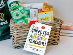 a basket filled with school supplies sitting on top of a table next to other items