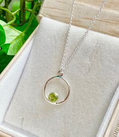 "Sweet and simple Sterling necklace with lovely Peridot ! The faceted, bright apple green Peridot is nestled in Sterling silver bezel with an open back. This Peridot necklace is a perfect gift for someone born in August since Peridot is their birthstone. The Sterling silver chain is adjustable from 14-22 inches. Simply glide the chain through the silver bead at the clasp to your desired length. Also appropriate for a young girl. The necklace comes in a standard gift box. FOR GIFT GIVING: ** Sati Green Peridot Necklace For May Birthstone, Lime Green Peridot Necklace For May Birthstone, Round Peridot Birthstone Necklace, Green Peridot Necklace For Gift, Lime Green Necklace Gift For May Birthstone, Lime Green Necklace For May Birthstone Gift, Lime Green Birthstone Jewelry Gift, Lime Green Birthstone Jewelry For Gifts, Green Sterling Silver Birthstone Necklace With Round Pendant