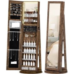 an open wooden jewelry cabinet next to a mirror