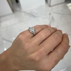 a woman's hand with a diamond ring on it