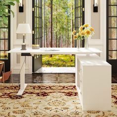 a white desk sitting in the middle of a living room next to a large window