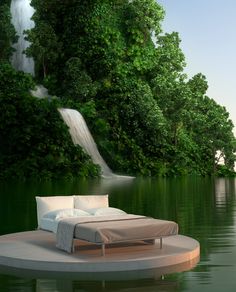 a bed sitting on top of a floating platform next to a forest filled with trees