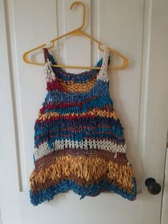 "Scrappy Vest This boho scrap vest/tank is light, airy, and great for warm weather. Layer over a cami, tank, or tee, or even a long-sleeved top.  Size S/M Measurements taken while garment laying flat.  Pit-to-pit: 17\" Bottom hem width: 22\" Length top of strap to hem: 21\" For reference, model is 5'2\", 140 lbs and typically wears size S to M.  Sustainability and environmental responsibility are important to me. For this reason, I primarily use use/incorporate leftovers from my existing yarn st Red Crochet Top, Summer Cotton Tops, 140 Lbs, Yarn Stash, Summer Tank Tops, Knit Or Crochet, Strap Tops, Colorful Boho, Summer Cotton