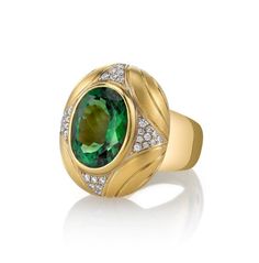 A vibrant, rich green 10.31 carat tourmaline oval is featured in this gorgeous, custom-designed 18k yellow gold ring. The tourmaline is a gem in every respect, possessing exceptional color, excellent clarity and a beautiful cut. This regal-looking ring was designed especially to showcase this magnificent gemstone and combines an elegant brushed finish with high-polished detail to complement and contrast the wide, rounded high-polished band. Thirty-six sparkling round brilliant cut white diamonds Luxury Oval Tourmaline Emerald Ring, 14k Gold Green Gemstone Dome Ring, Luxury Tourmaline Jewelry With Oval Cabochon, Gold Tourmaline Rings With Polished Finish, Yellow Gold Tourmaline Ring With Polished Finish, Luxury Tourmaline Cabochon Rings, Gold Engraving, Rich Green, Domed Ring