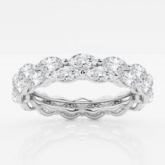 a white gold wedding ring with three rows of diamonds on the side and an intricate band